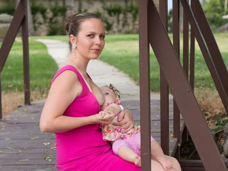 Mother breastfeeding her baby outdoors