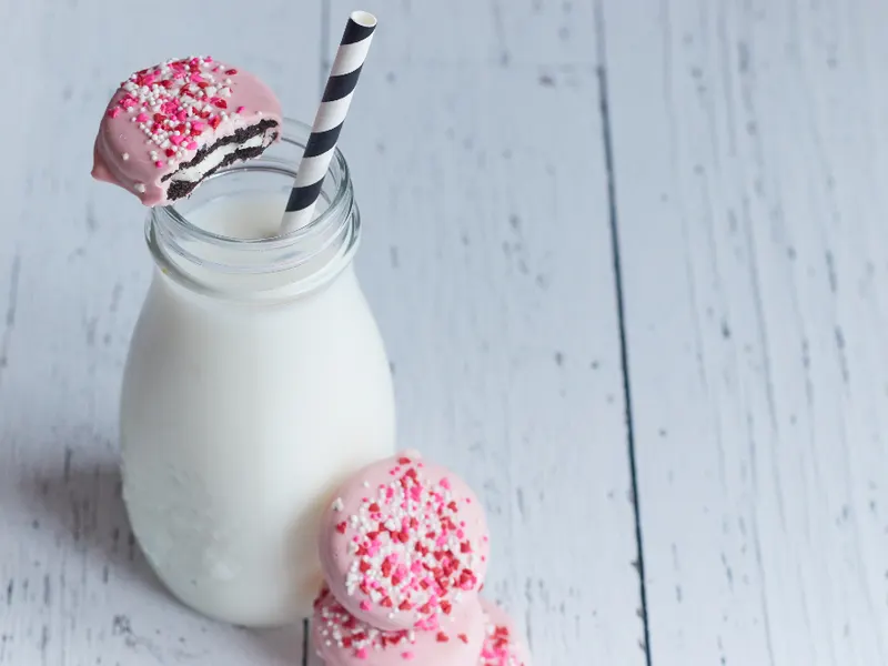 Glass milk bottle with a striped straw
