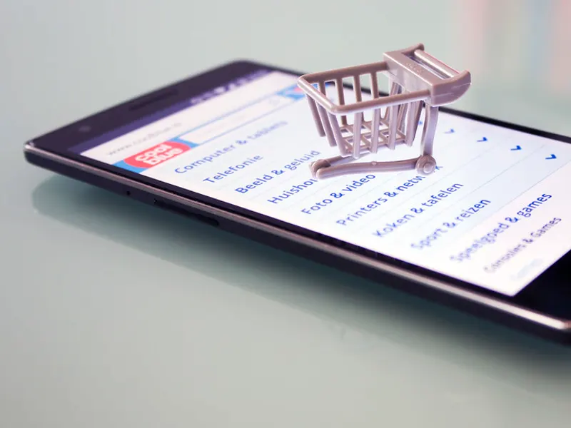 Miniature shopping trolley on a smartphone screen