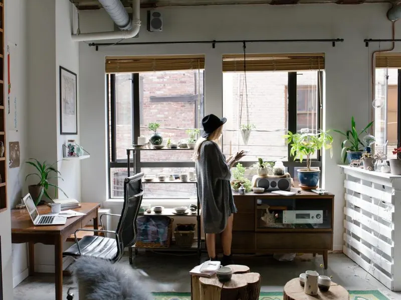 Woman at her home-office desk by a bright window