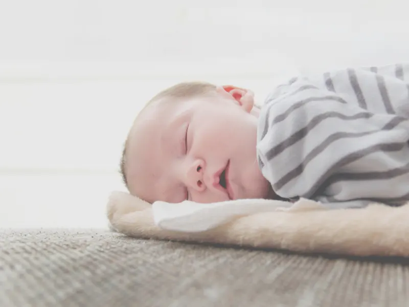 Newborn baby sleeping peacefully on a soft blanket