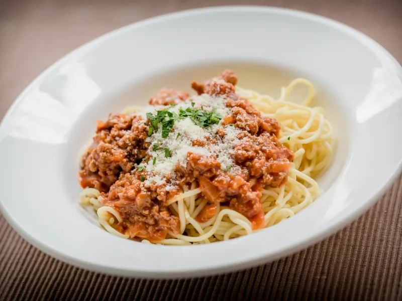 Bowl of spaghetti with tomato sauce and parmesan