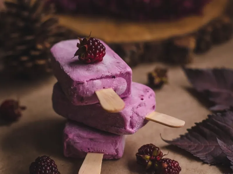 Stacked fruit ice lollies with fresh berries