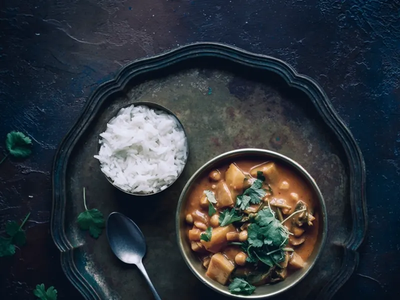 Bowl of chickpea curry with rice and coriander