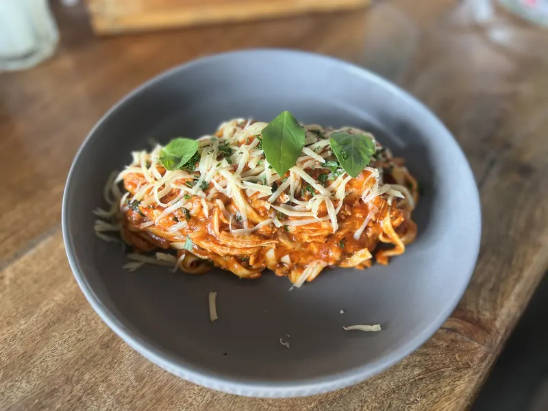 Bowl of spaghetti bolognese with fresh herbs