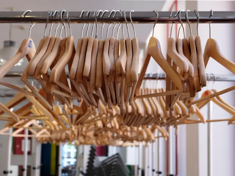 Row of wooden clothes hangers on a rail