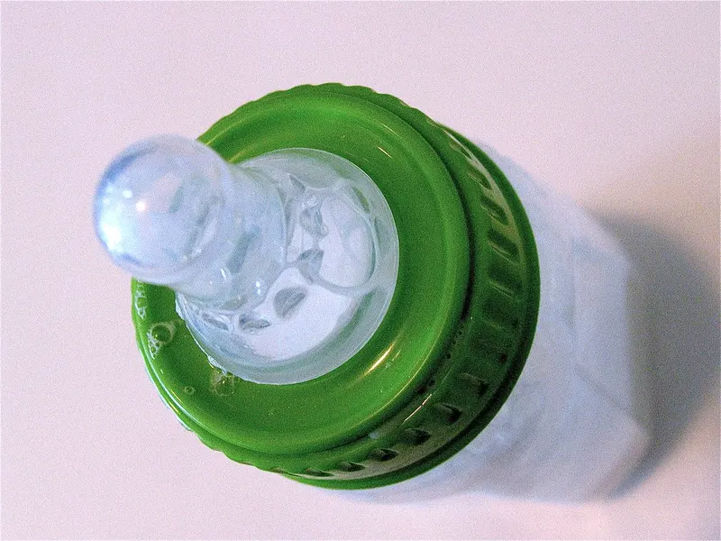 Close-up of a baby bottle teat and cap