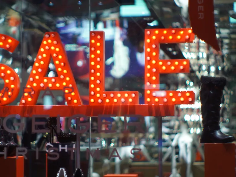 Illuminated sale sign in a shop window